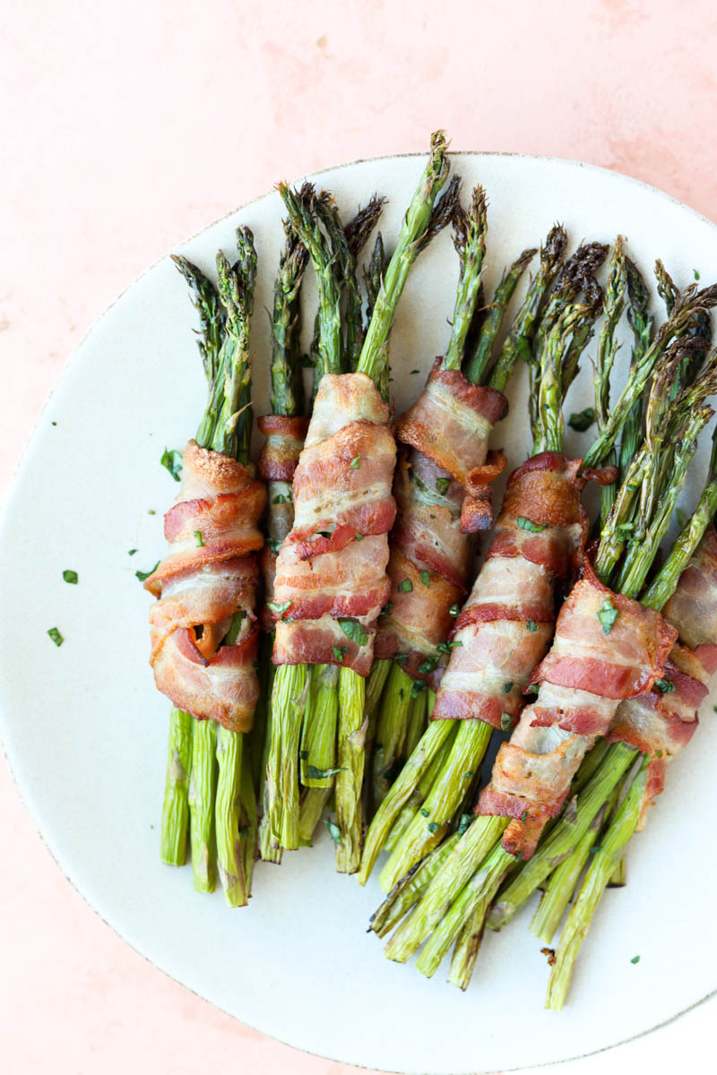 Close up picture of plate with bacon wrapped asparagus.
