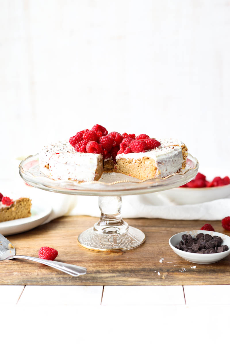 Vanilla cake on a glass cake stand.
