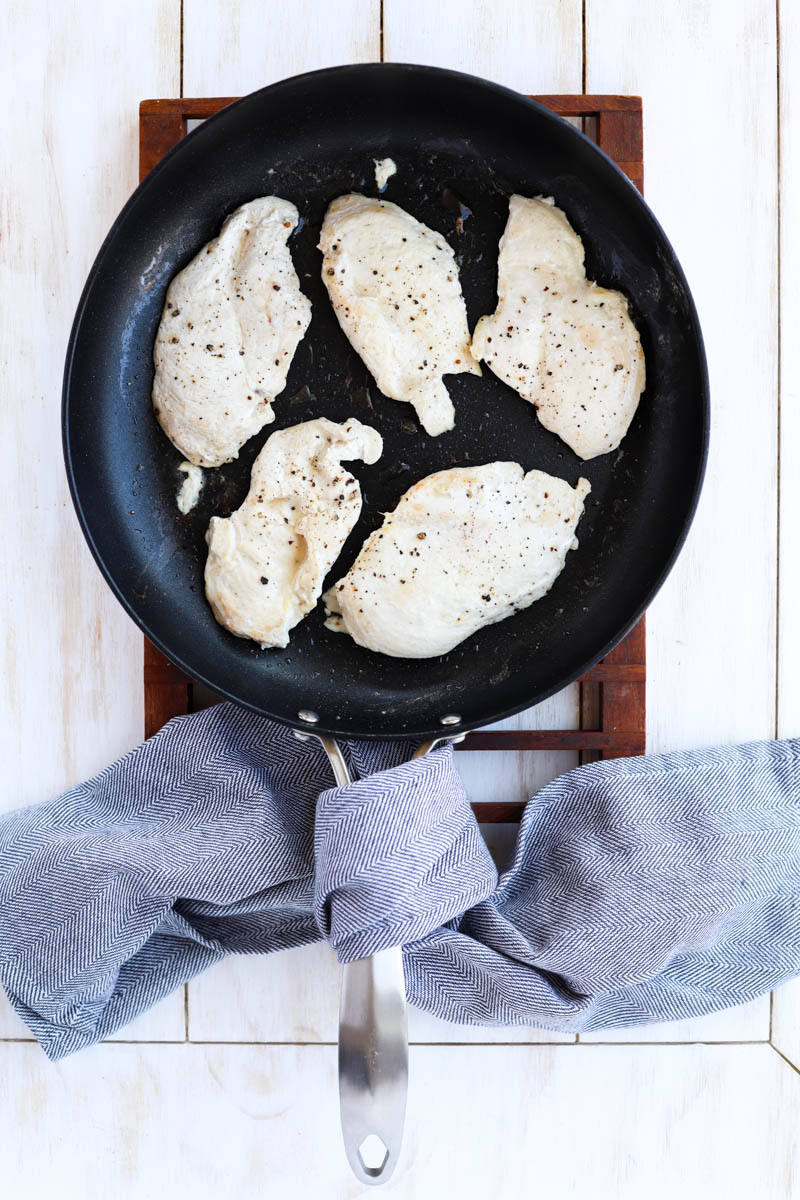 Chicken cooking in sauté pan.