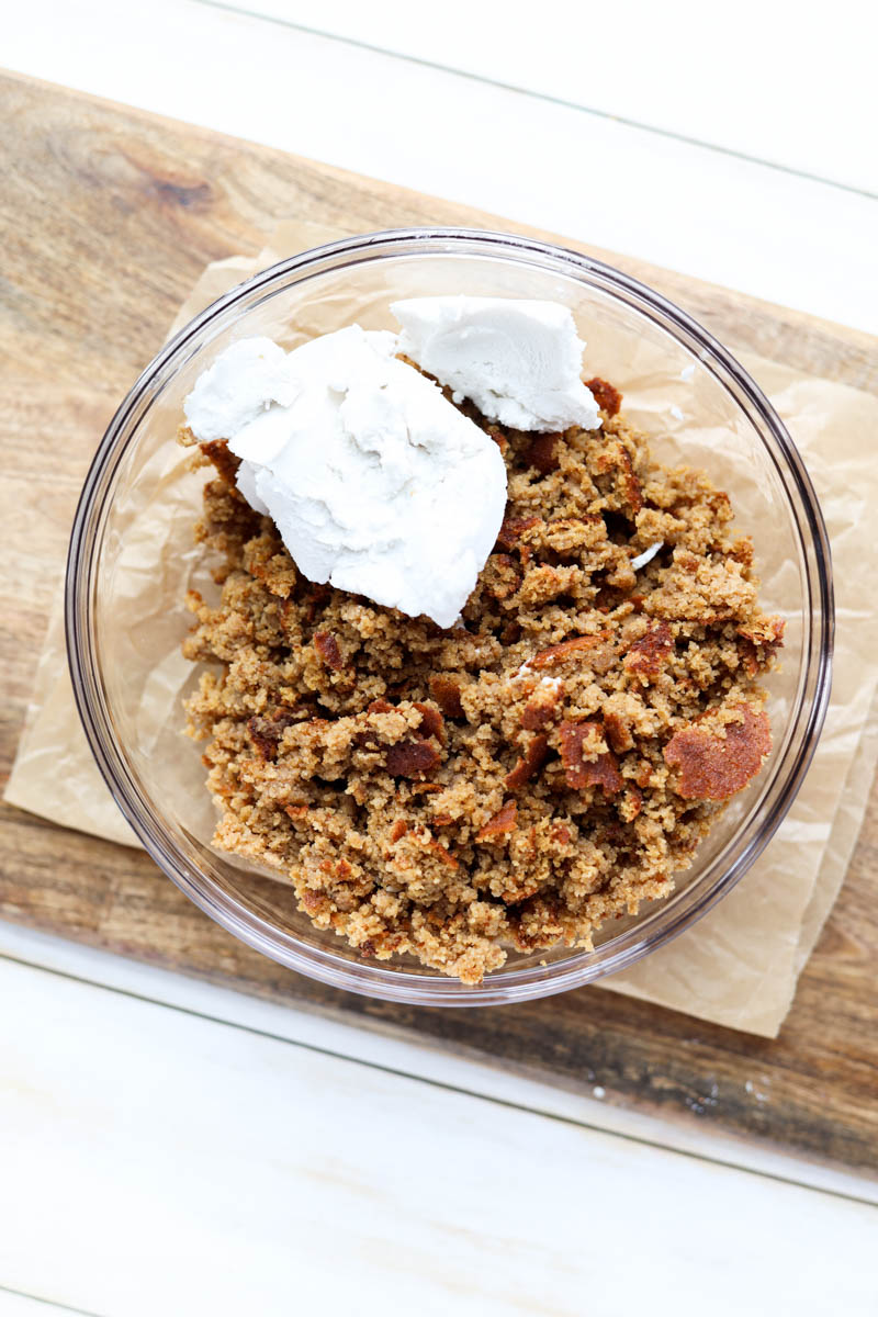 Cake crumbles and coconut milk in glass bowl.