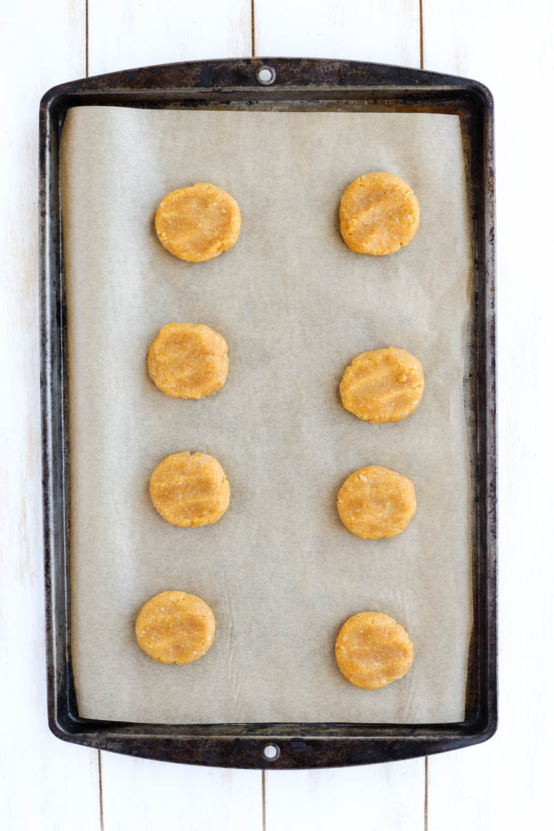 Lemon cookies on parchment paper lined baking tray.