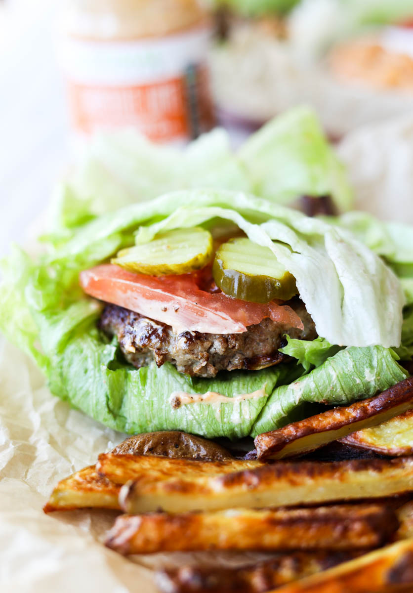 Juicy burger with tomato, pickles and lettuce.