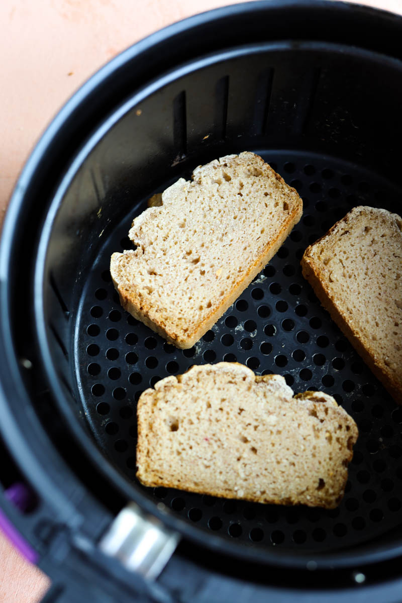 Gluten-free bread slices in air fryer.