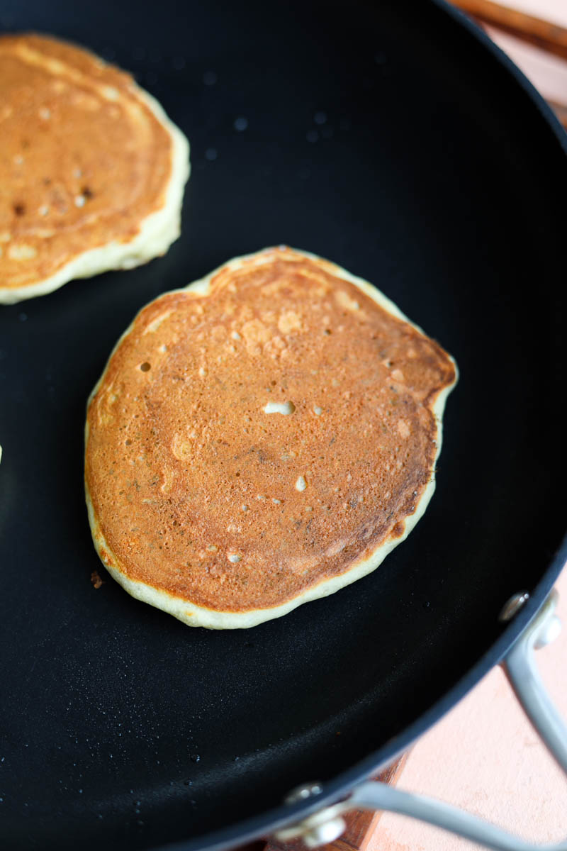 Cooked golden brown pancake on skillet.
