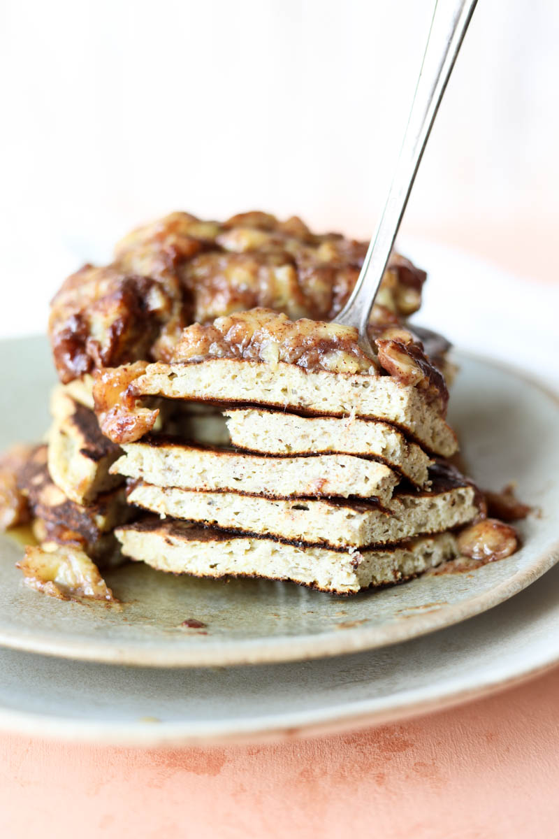 Fork holding a big bite of pancakes.