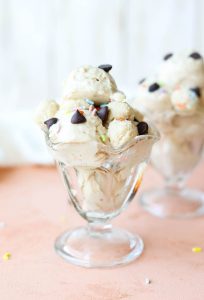 Cookie dough nice cream in a glass ice cream cup.