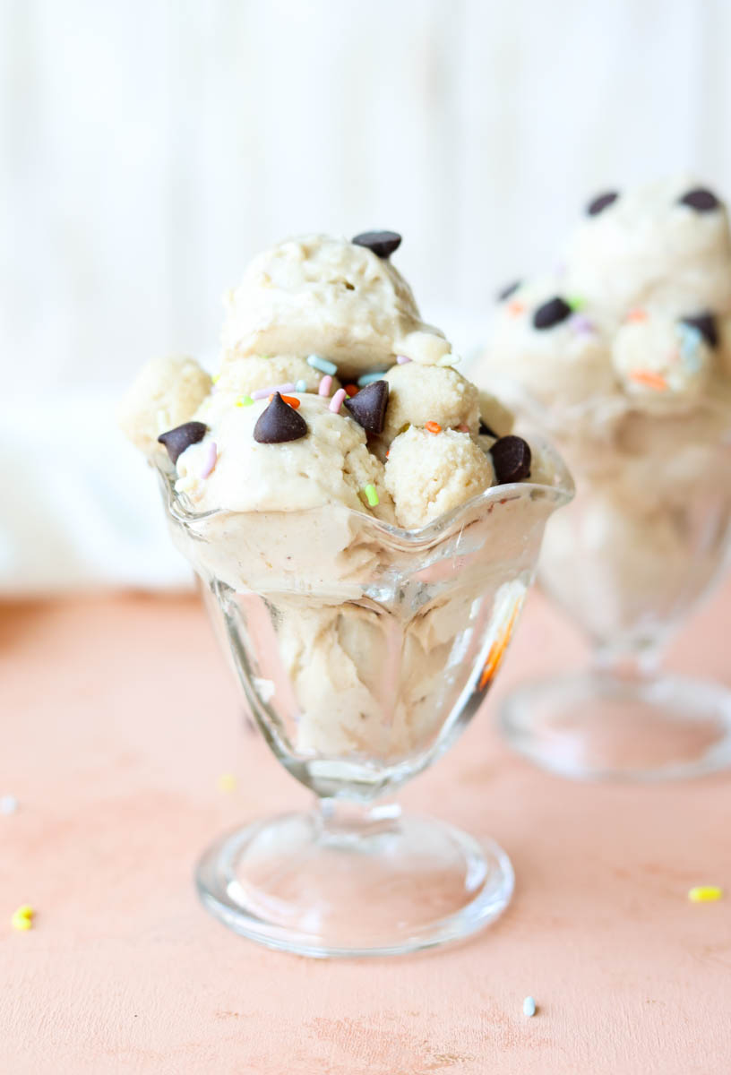 Cookie dough nice cream in a glass ice cream cup.