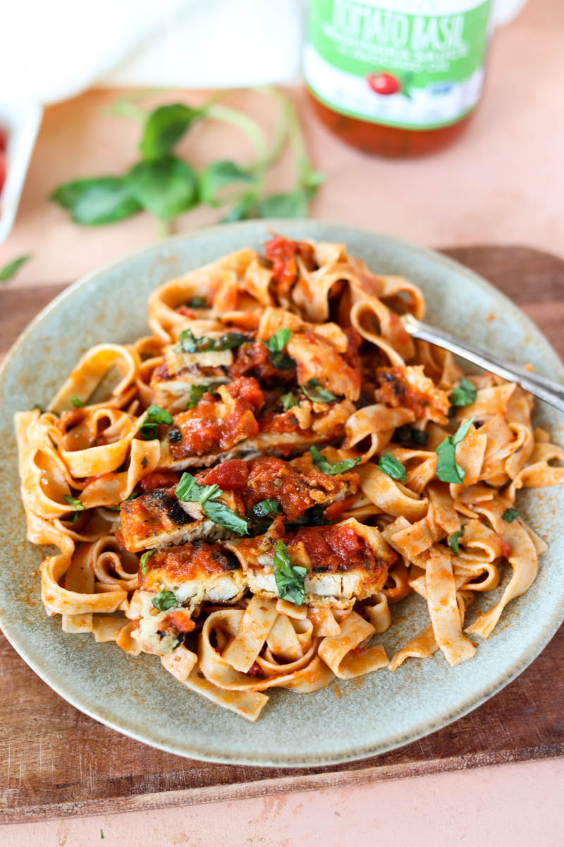 Clay plate with chicken parm and fettucine.