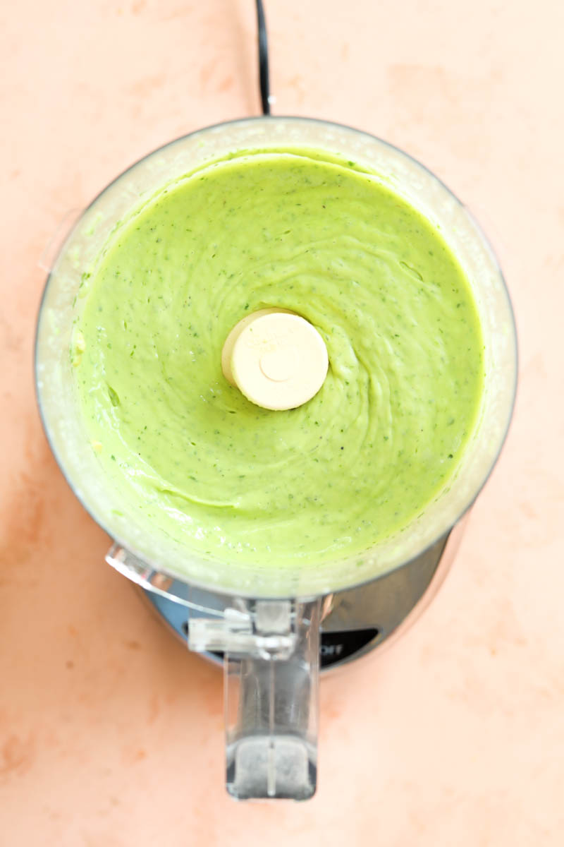 Creamy avocado dressing in a food processor.