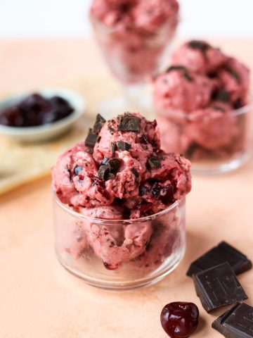 Cherry garcia nice cream in a glass bowl.
