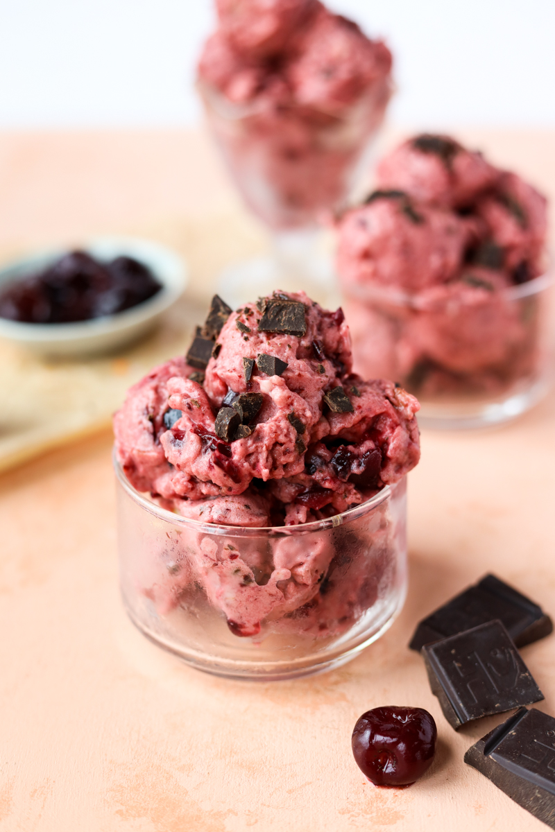 Cherry garcia nice cream in a glass bowl.