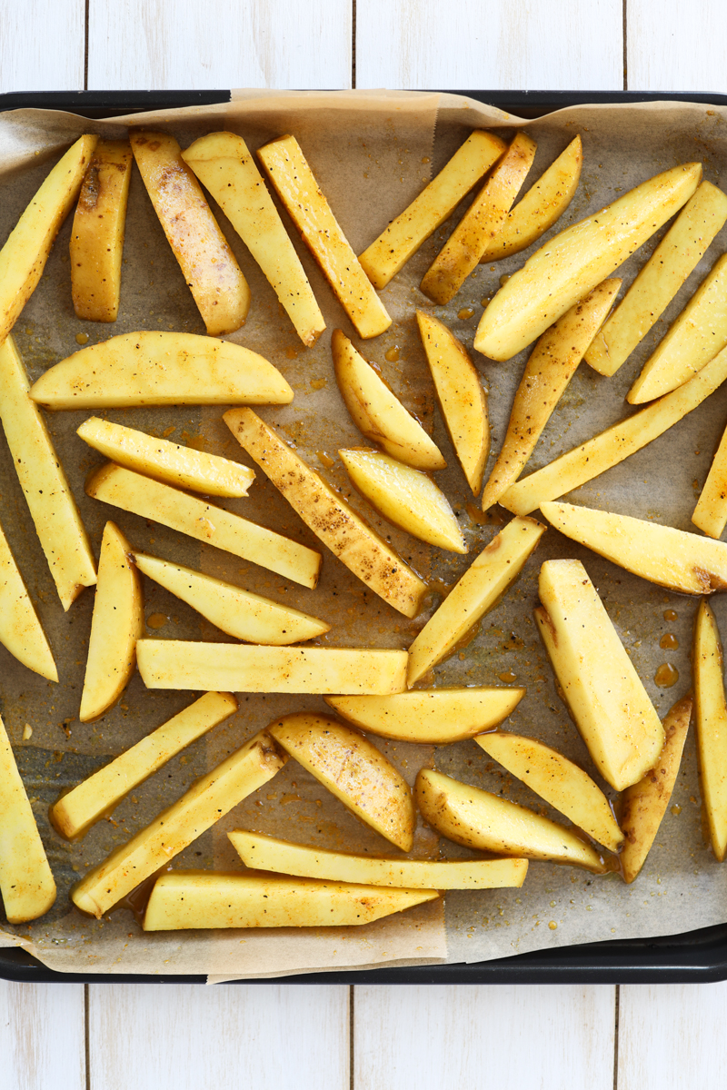 Potatoes on a baking sheet lined with parchment paper.
