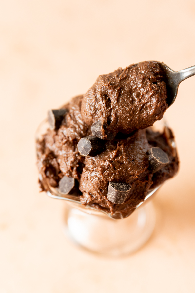 Spoon scooping out brownie batter.