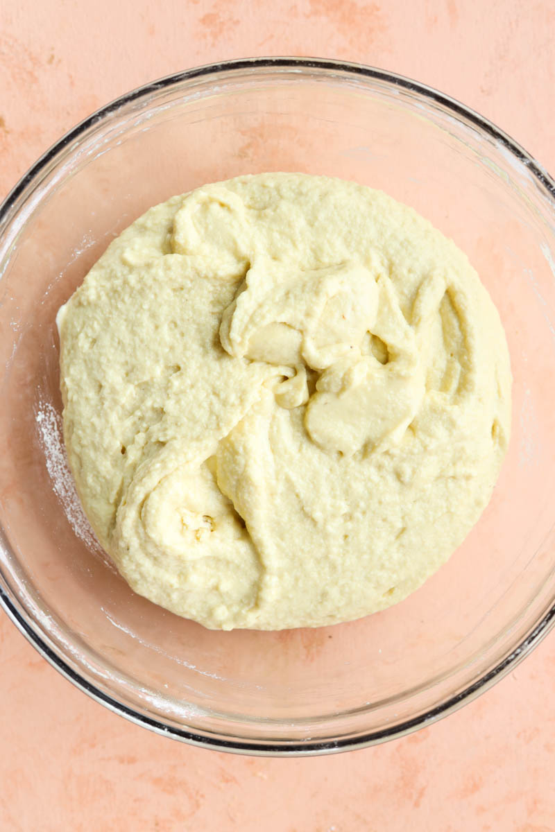 Bread dough in glass bowl.