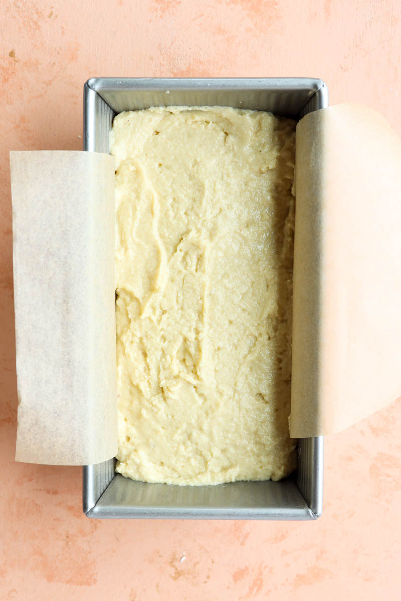 Dough in bread pan lined with parchment paper.