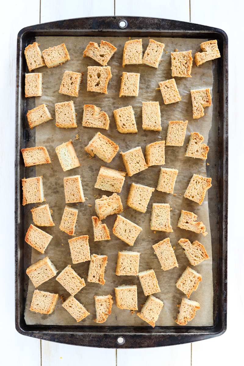 Golden brown croutons on a baking sheet.