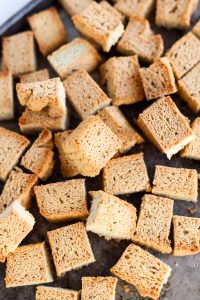 Golden brown croutons on a baking sheet.