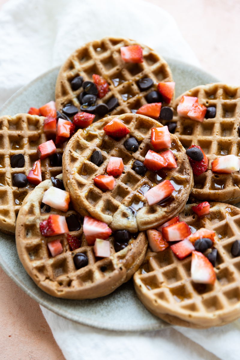 Mini waffles with chopped strawberries and chocolate chips.