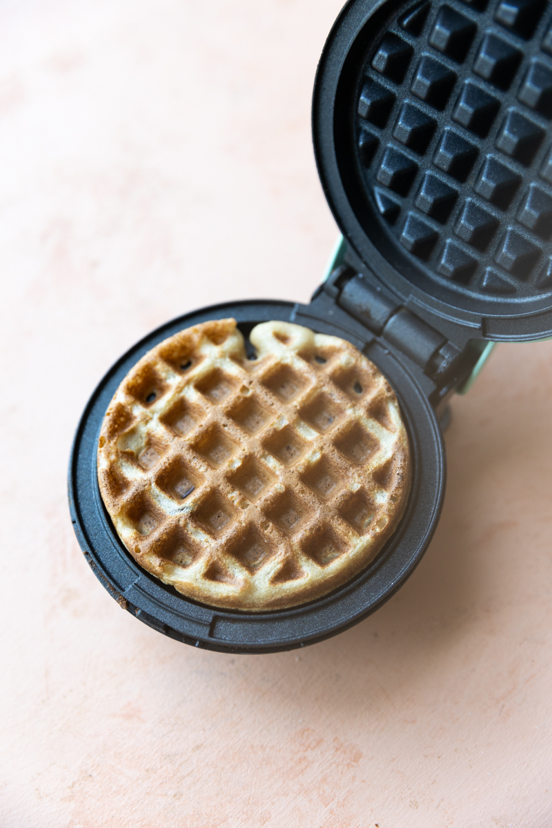 Cooked waffle in mini waffle maker.