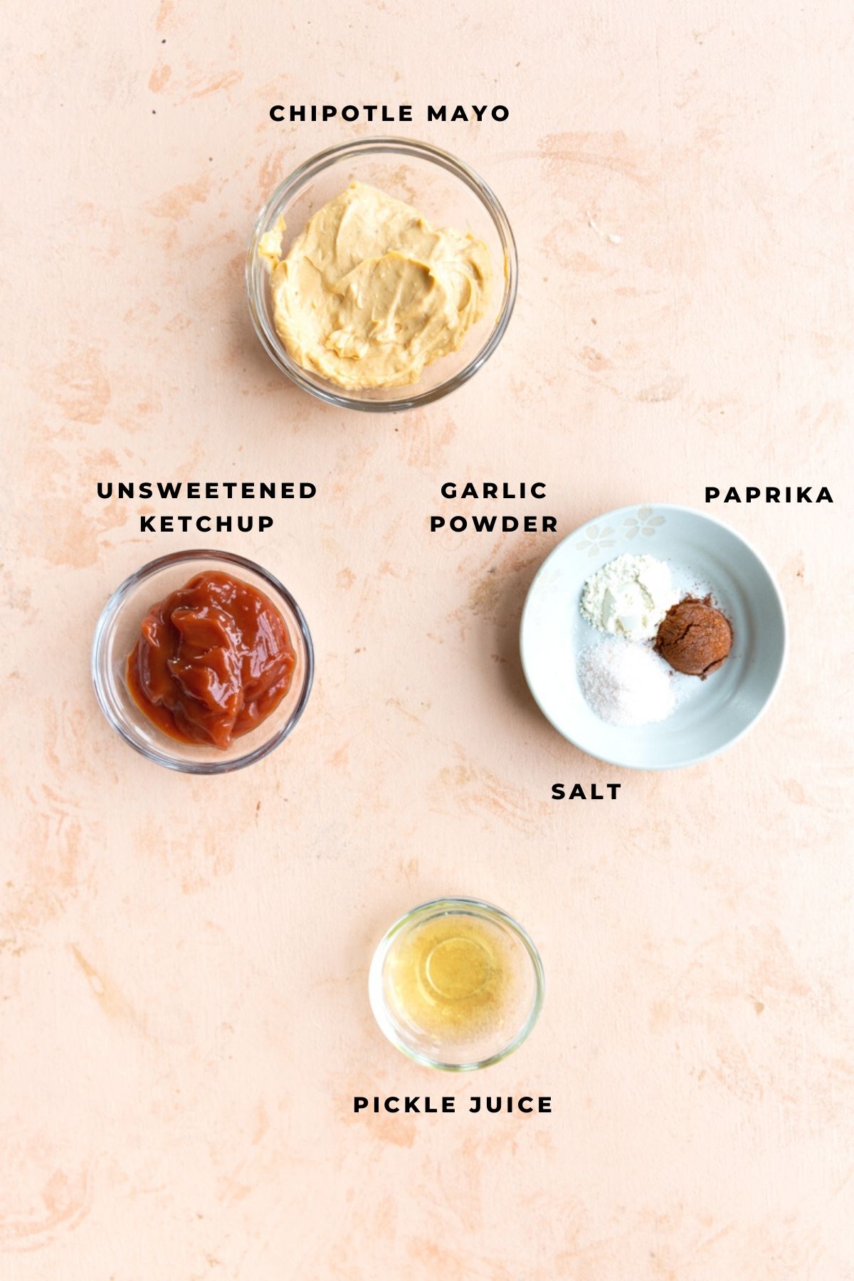 Spicy burger sauce ingredients measured out in glass jars.