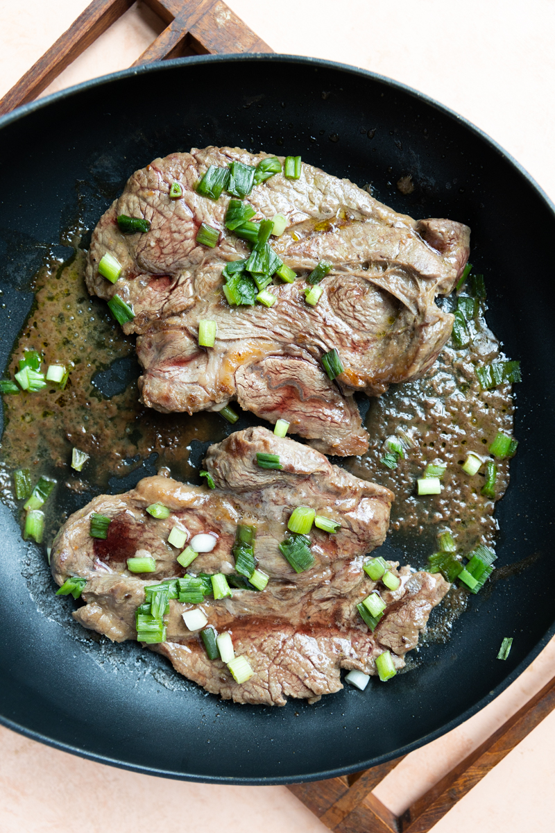 Steak cooked in skillet.