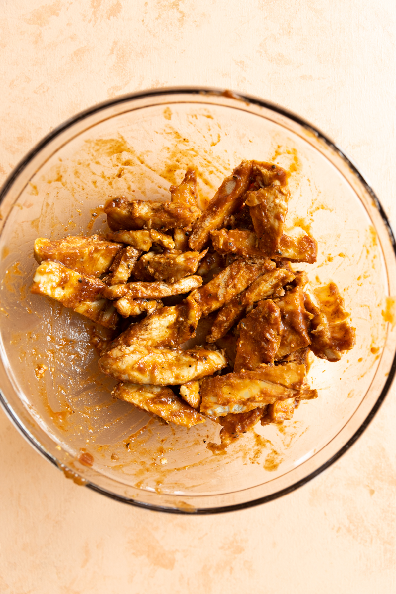 Sliced chicken tossed in bbq sauce.