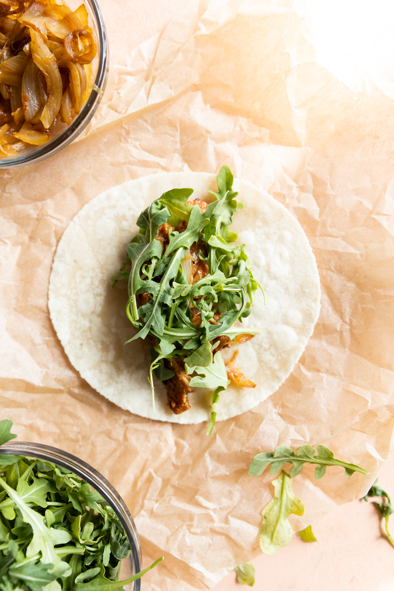 Chicken, onions, and arugula in a grain free wrap.