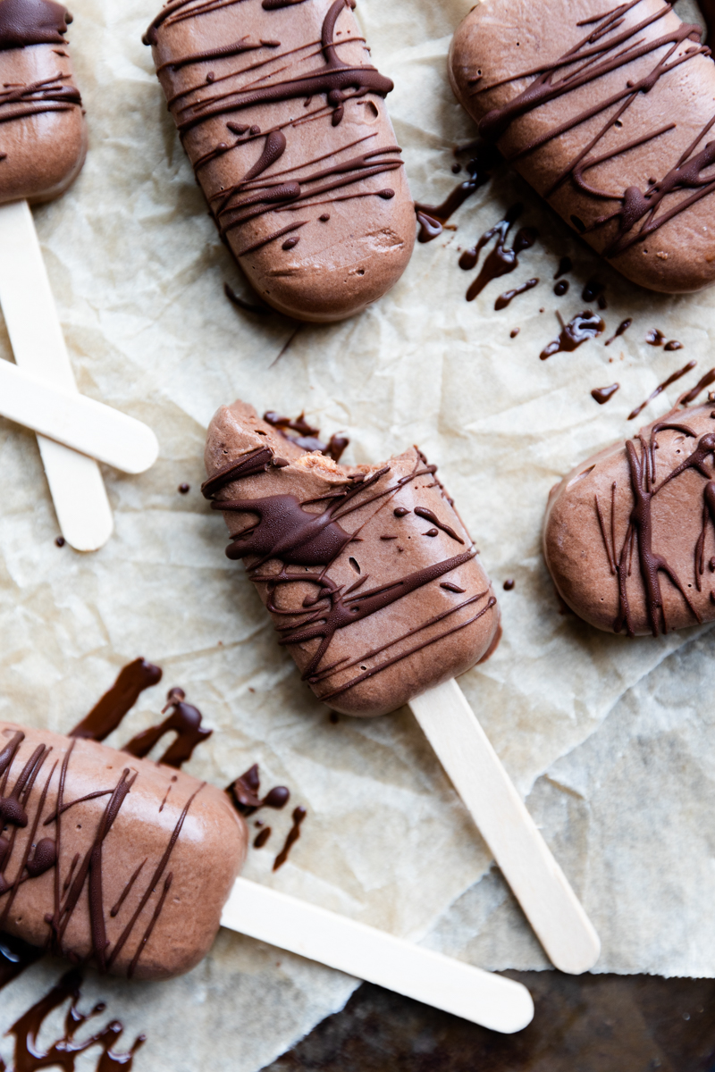 Chocolate ice cream bars with a chocolate drizzle.