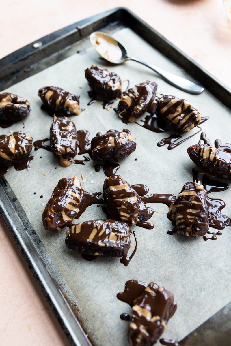 Dates stuffed with peanut butter that are drizzled with chocolate.