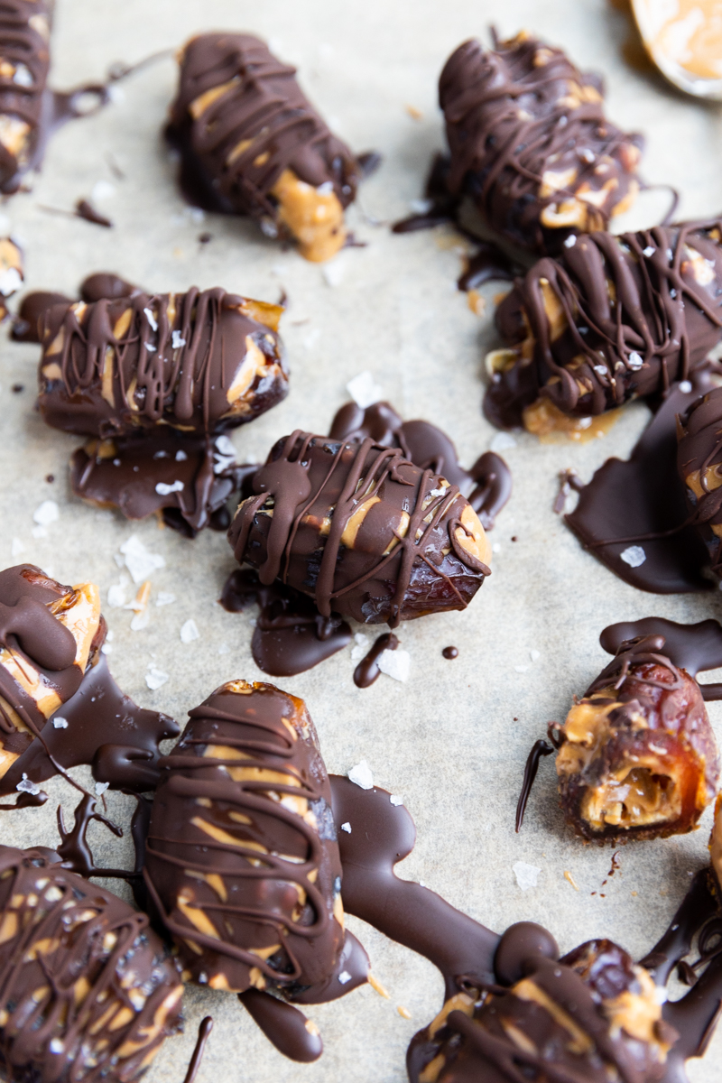 Snickers Dates chilled on parchment paper.