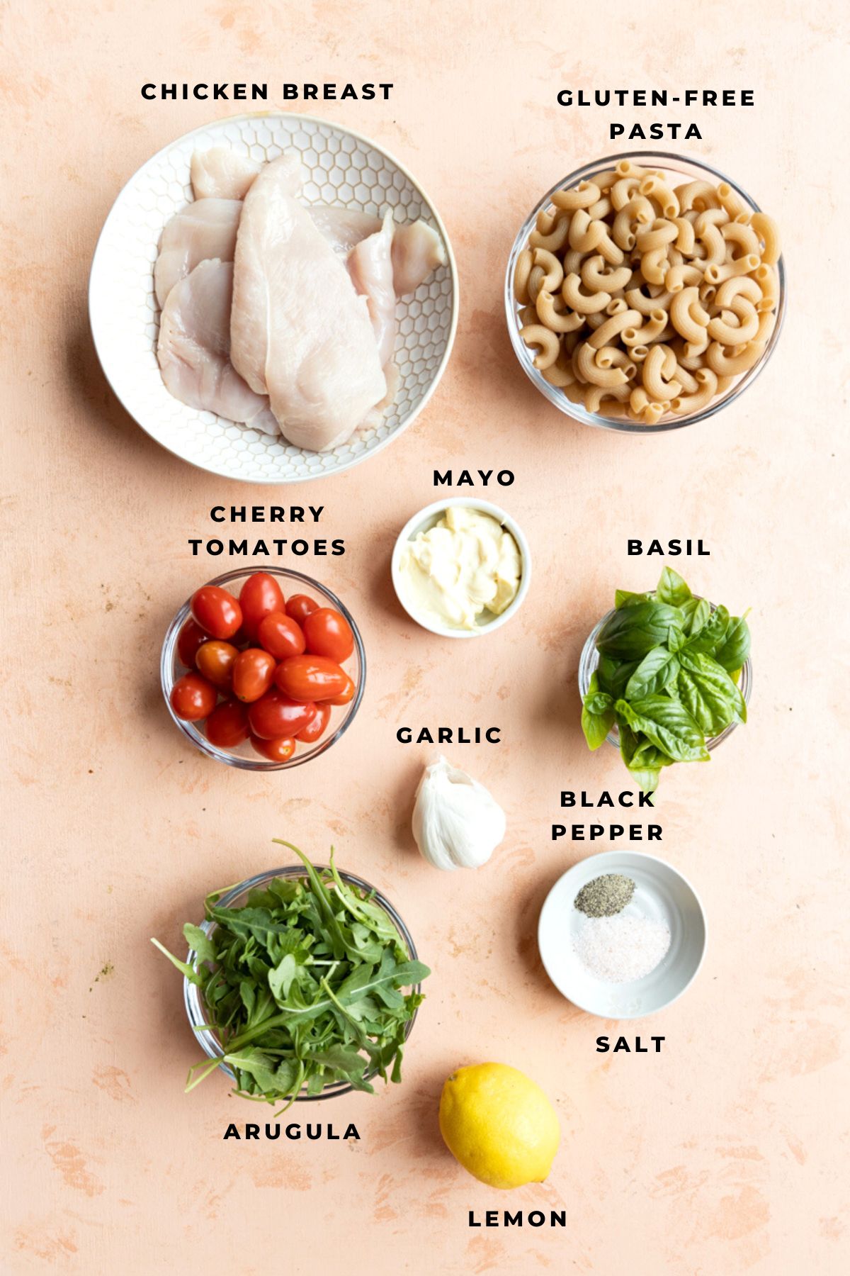 Pesto chicken pasta salad ingredients measured out into small cups.