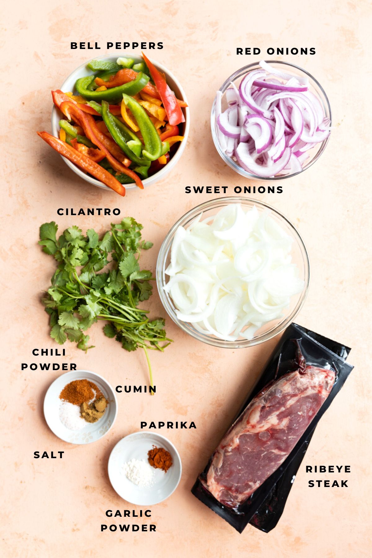 Steak fajita ingredients measured out into small containers.