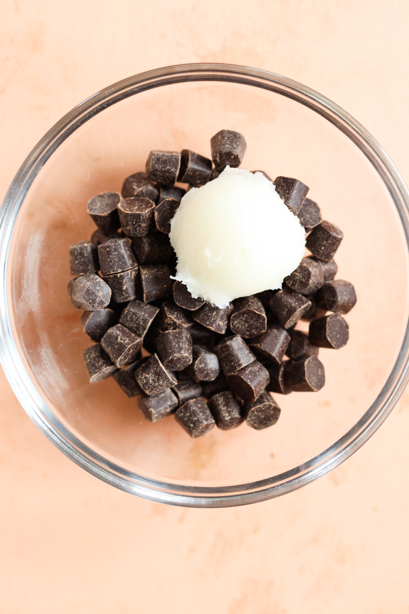 Chocolate chips in a bowl with coconut oil.