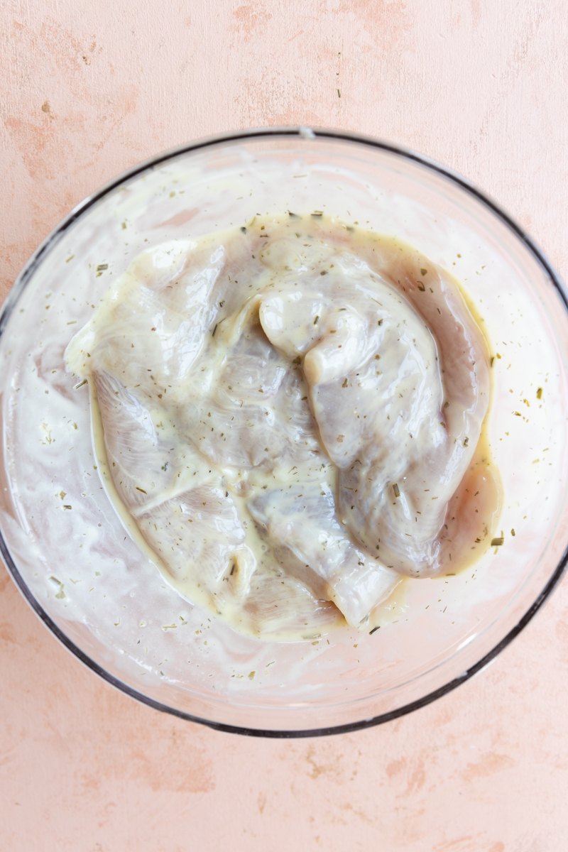 Chicken breast marinating in ranch dressing.