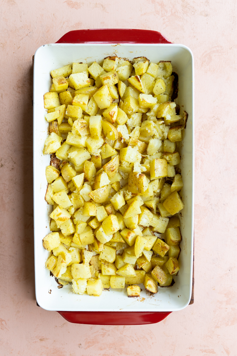 Baked potatoes in casserole dish.