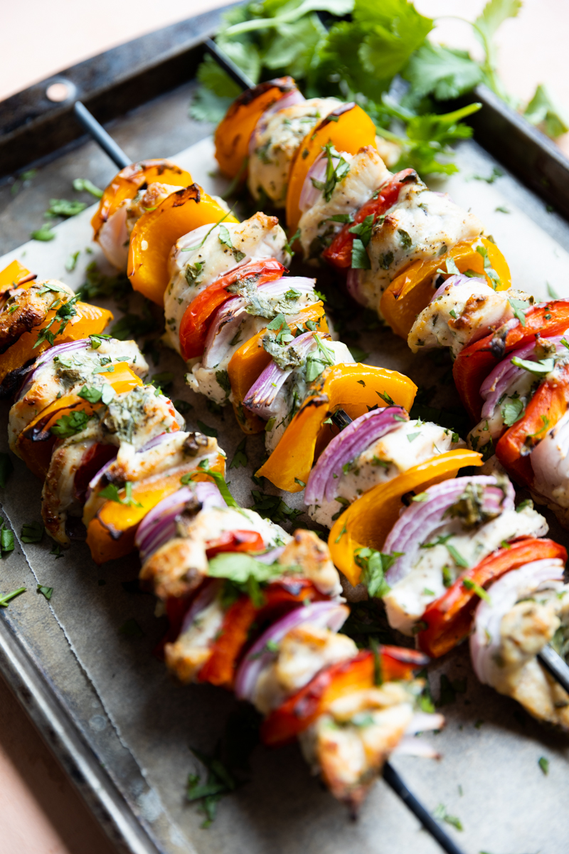 Air fryer chicken kabobs on a baking sheet.
