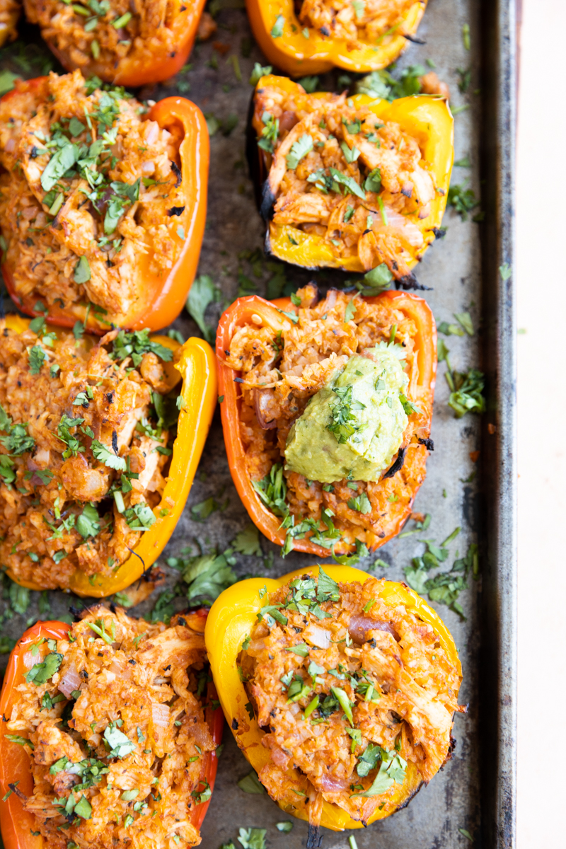 BBQ Chicken Peppers lined up on a baking sheet.