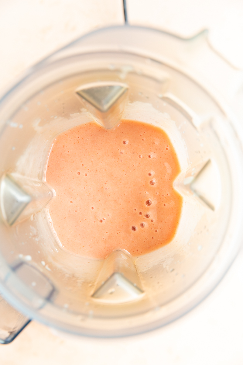 Mango strawberry smoothie in a blender.