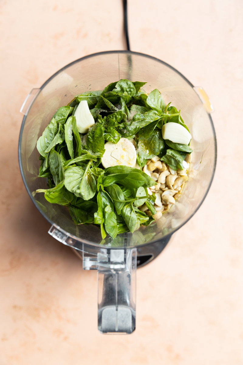 Pesto ingredients in a food processor.