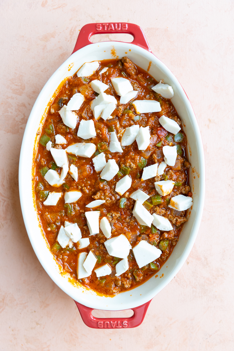Pizza Bowl in casserole dish with dariy free cheese on top.