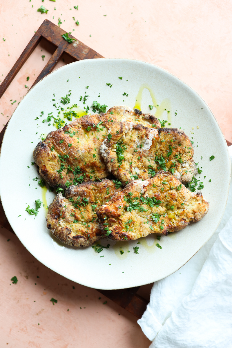 Crispy Italian Chicken Cutlets on a white ceramic plate.