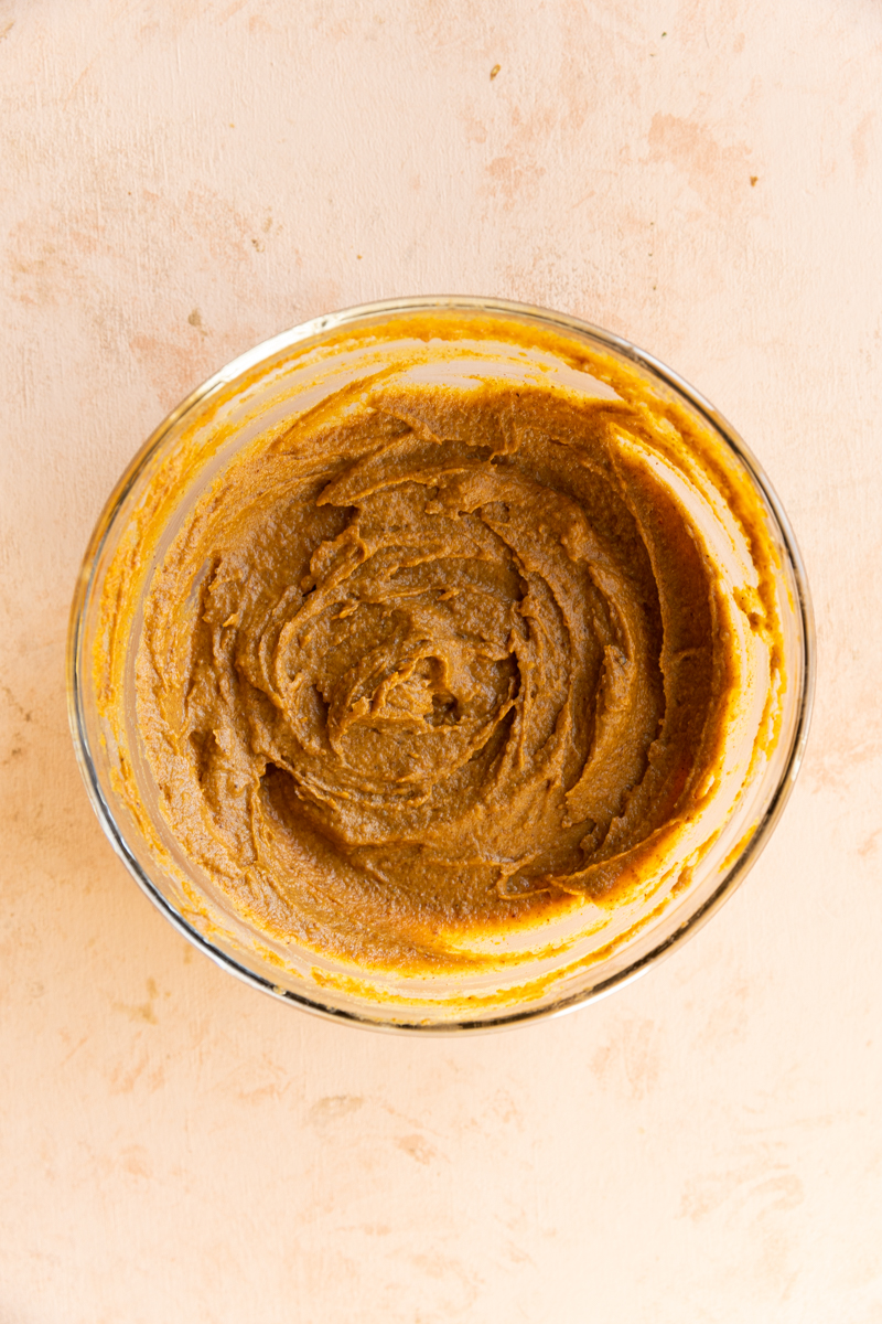Pumpkin spice filling in glass mixing bowl.