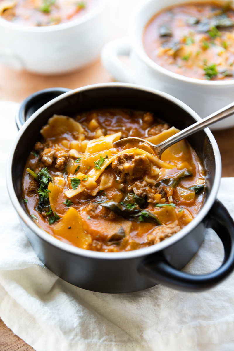 Spoon scooping out a bite of lasagna soup.