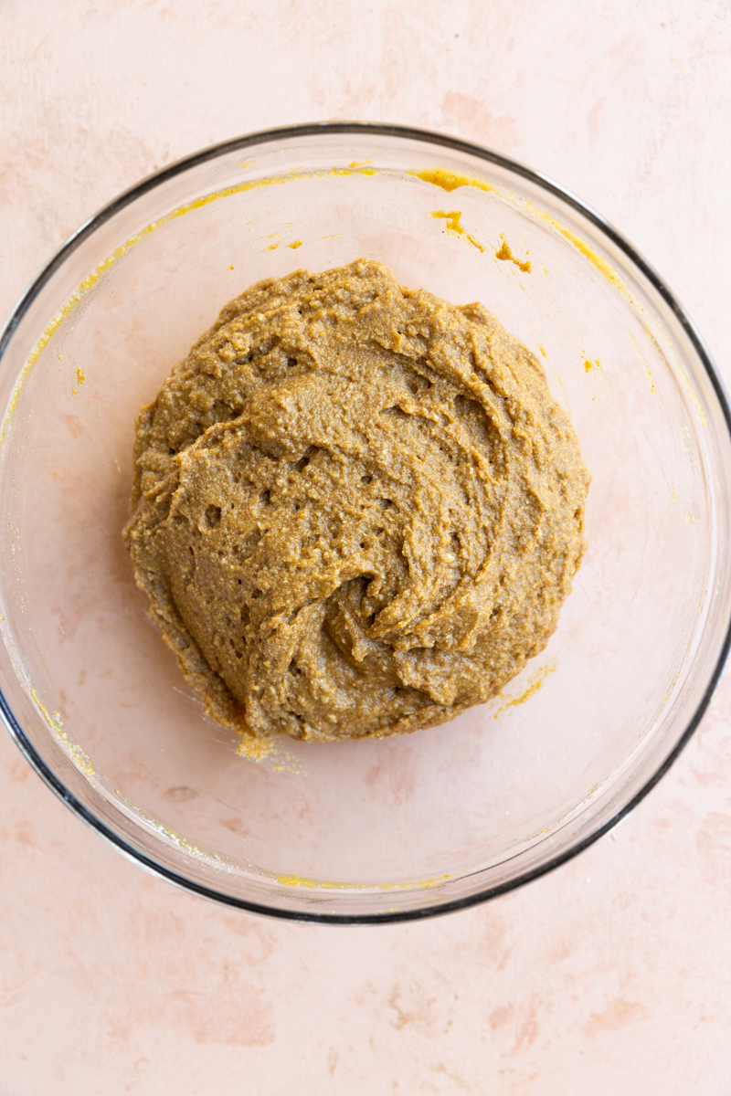 Pumpkin bread batter in a glass mixing bowl.