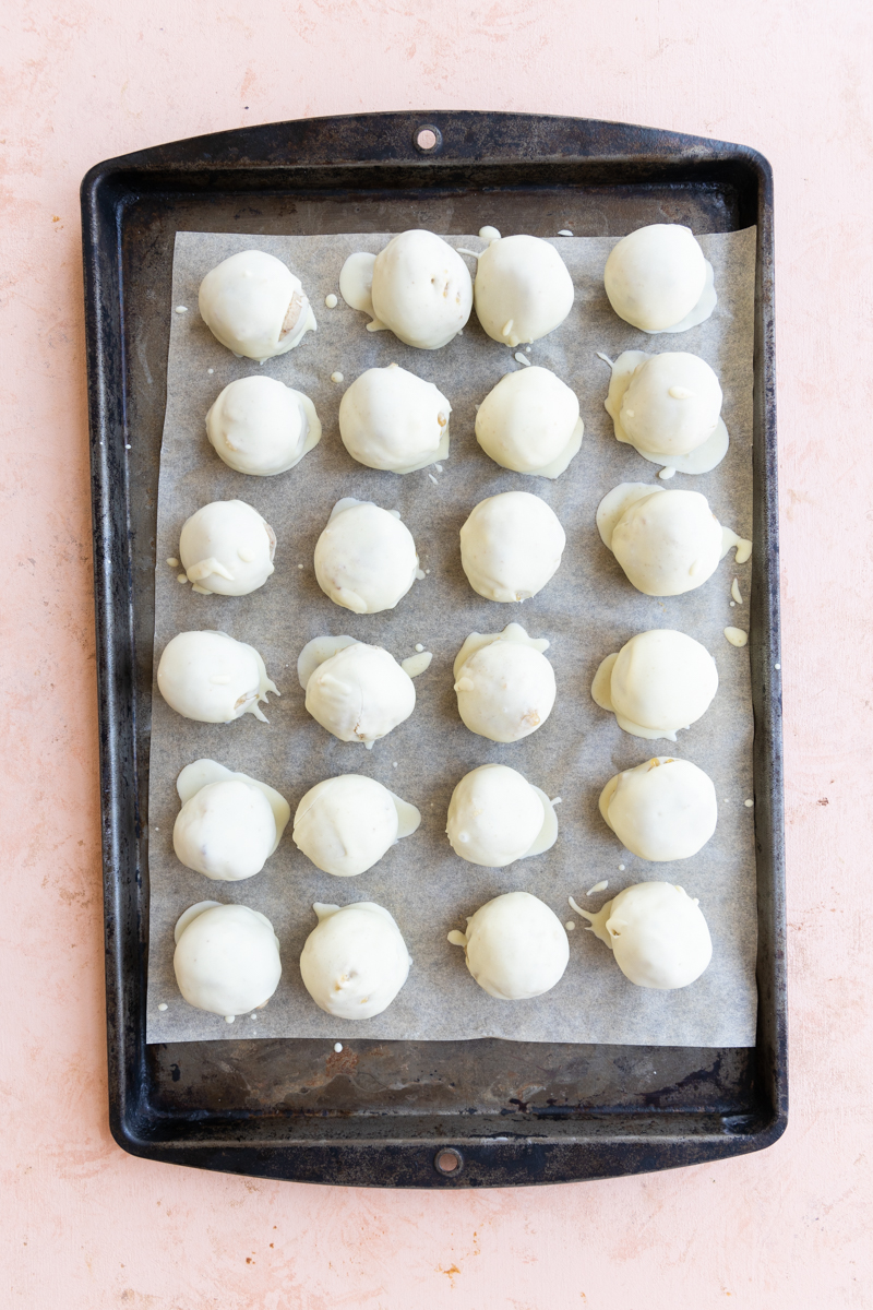Cake pops dipped in white chocolate.
