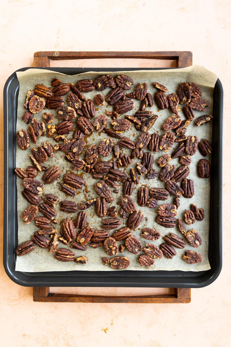 Toasted candied pecans on baking tray.