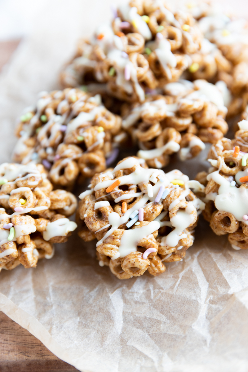 Cereal cookies with white chocolate drizzle and rainbow sprinkles.