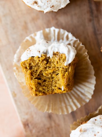 Pumpkin protein muffin with a big bite taken out.