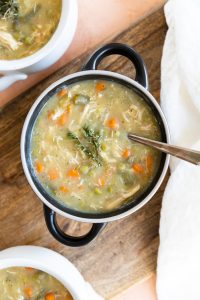 Overhead picture of chicken pot pie soup in a black ceramic bowl.
