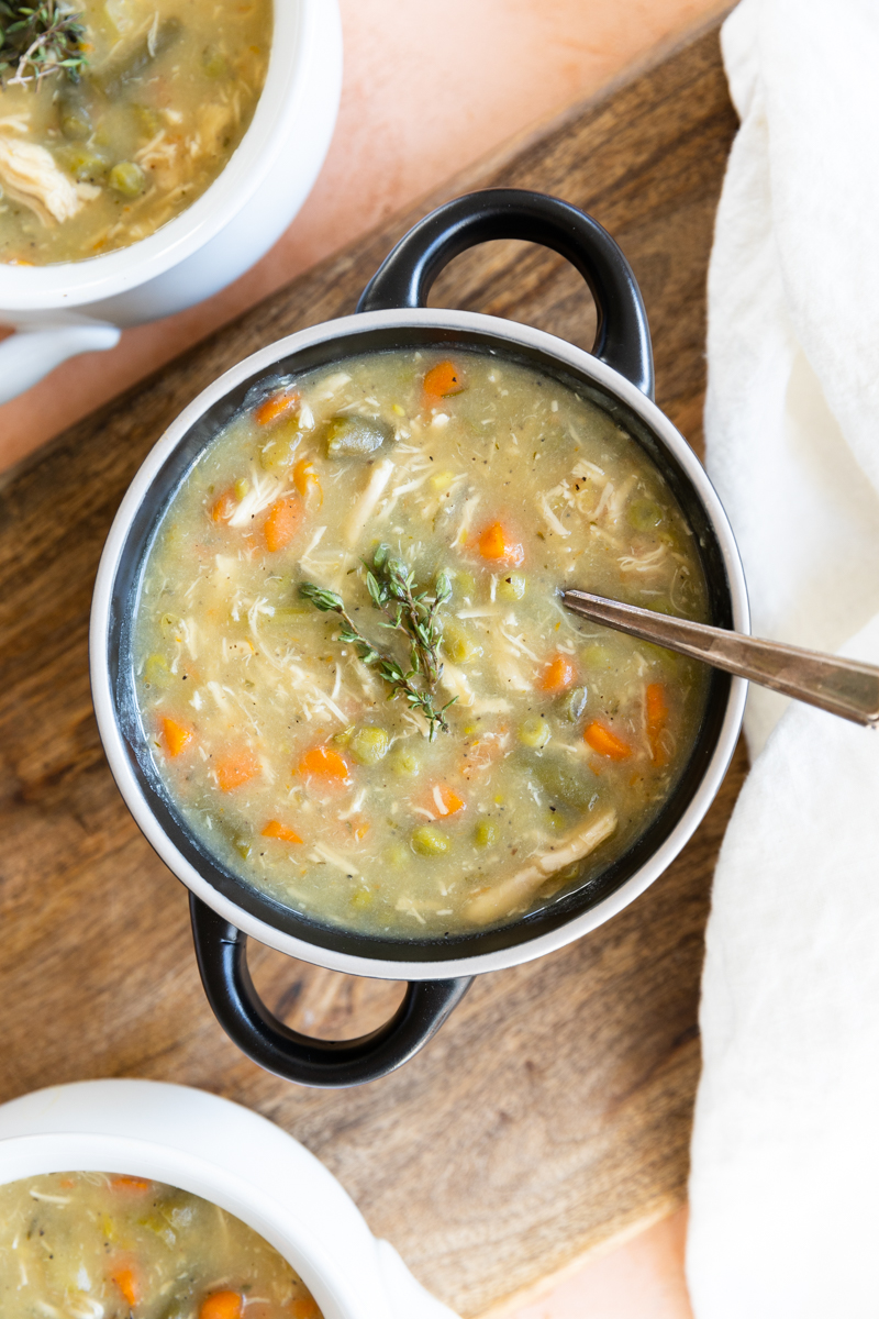 Overhead picture of chicken pot pie soup in a black ceramic bowl.